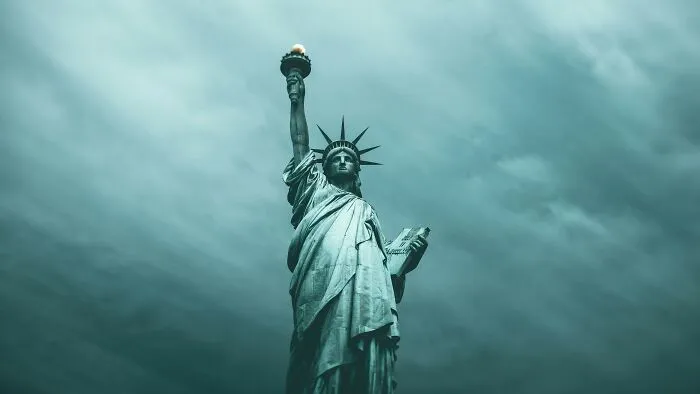 Statue of Liberty sculpture standing tall against a cloudy sky, a spectacular landmark for travel bucket lists.