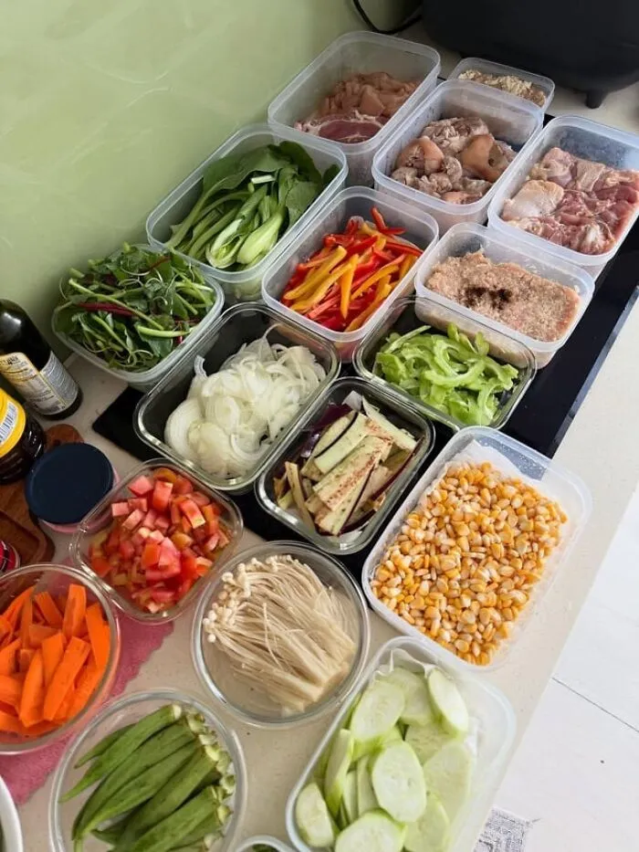 Meal prep containers filled with fresh vegetables and meats, showcasing kitchen tips and tricks for better cooking skills.