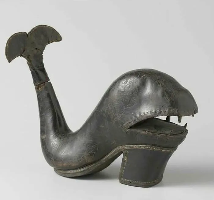 Antique whale-shaped shoe made of leather, a very old object reflecting craftsmanship from our ancestors.
