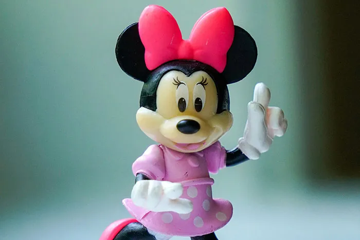 Figurine of Minnie Mouse in a pink dress and bow, symbolizing the scariest things people have woken up to stories.