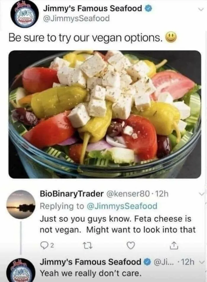 Tweet from a seafood restaurant promoting vegan options featuring feta cheese salad, sparking a humorous vegan debate online.