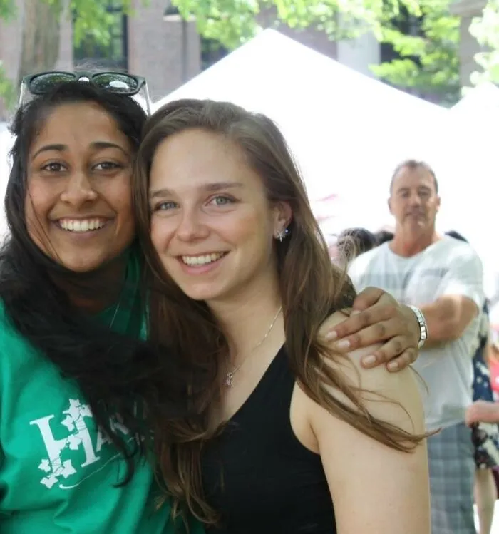The Man In The Back Of His Picture Looks Like His Hand Is On The Girl's Shoulder