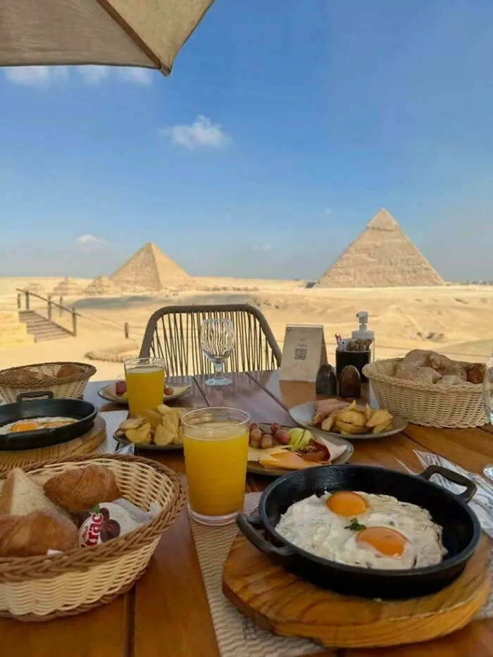 Breakfast with a view of the pyramids in Ancient Egypt, showcasing traditional scenery and local dining experiences.