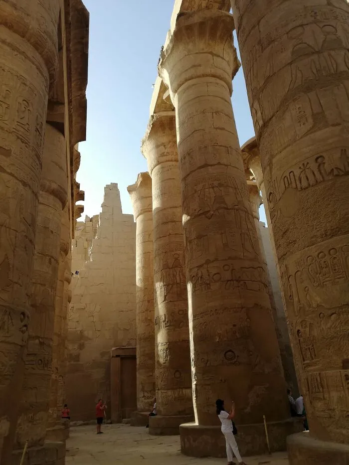 Massive columns in ancient Egyptian temple covered with hieroglyphs, showcasing incredible photographs from ancient Egypt.