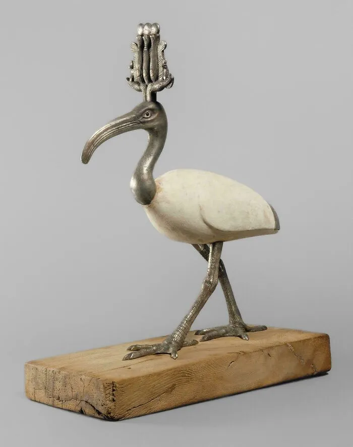 Silver and white ancient Egyptian ibis statue on a wooden base, an incredible artifact from ancient Egypt.