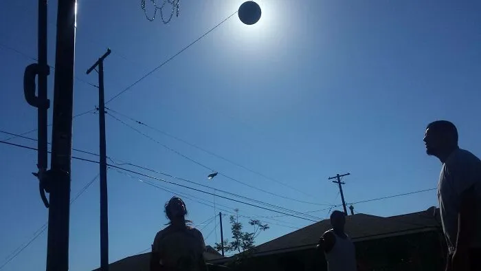 Took A Perfectly Timed Photo Of My Brother Shooting A Basketball. It Blocked Out The Sun To Make It Look Like A Solar Eclipse
