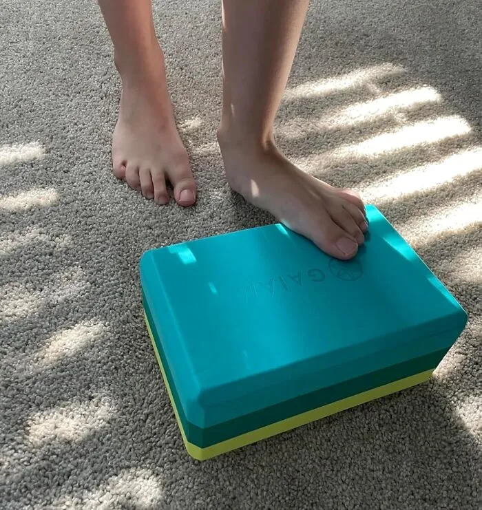 Admitting Defeat During A Stretch Is Actually Good For Your Health When You Use The <a Style="Display:inline;" Href="https://Www.amazon.com/Gaiam-Yoga-Block-Supportive-Latex-Free/Dp/B01icbtpnq?ie=utf8&th=1&linkcode=ll1&tag=bpmole-20&linkid=20656718d42fab7deadd8283e837cb0b&language=en_us&ref_=as_li_ss_tl" Target="_blank"> <span Style="Font: Inherit; Color: #d74b1f;"> Yoga Block </Span> To Bridge The Embarrassing Gap Between Your Hands And The Ground