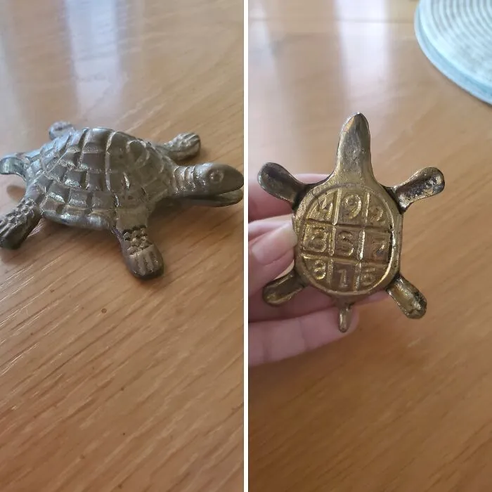Small metal turtle figurine with a magic square on its underside, one of the most bizarre things received as Christmas gifts.