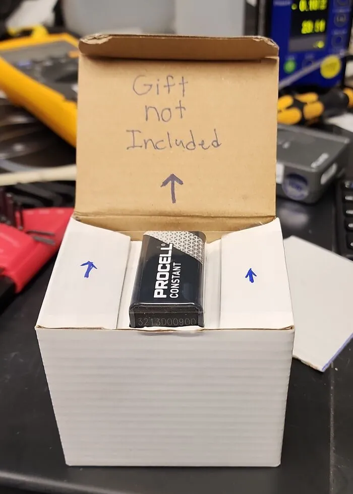 Small battery in large box with handwritten note gift not included, an example of bizarre Christmas gifts received by people.
