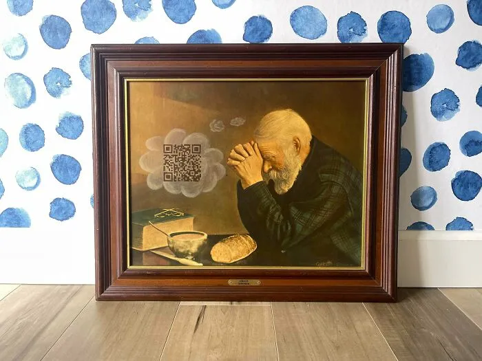 Thrifted painting of an elderly man praying with a humorous QR code added in the thought bubble above him.