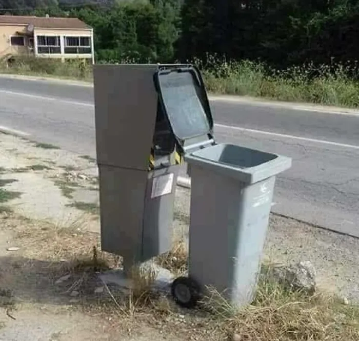 Trash bin repurposed as a mail delivery box on a rural roadside, a funny Eastern Europe life moment.