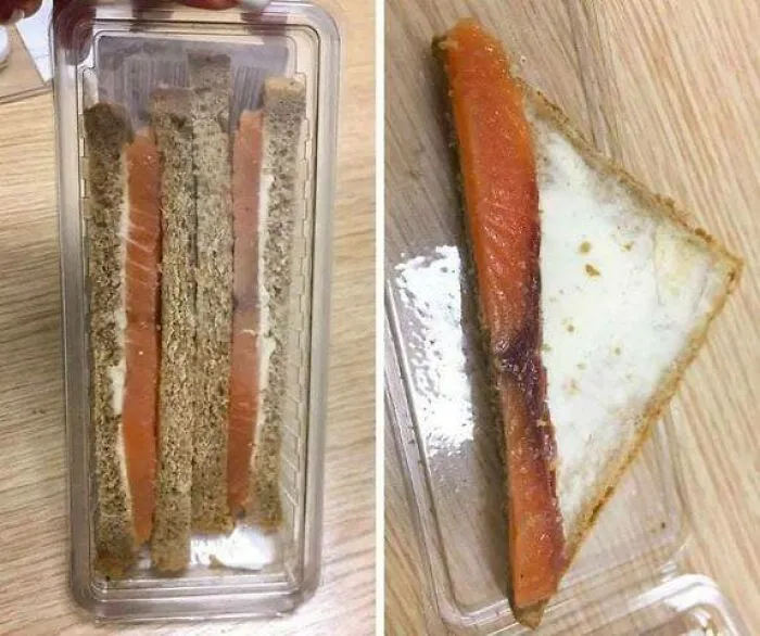 Thin smoked salmon sandwiches with cream cheese on rye bread in a plastic container, Eastern Europe snack humor.