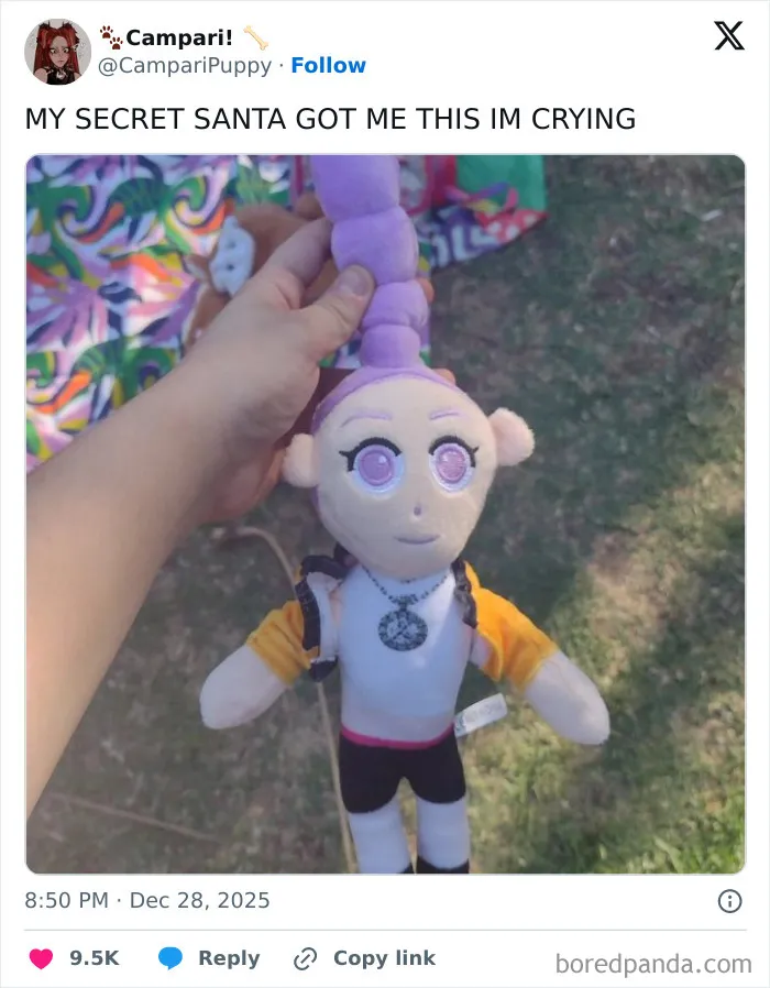 Hand holding a quirky plush doll with purple hair and large eyes, an example of hilariously bad Secret Santa gifts.