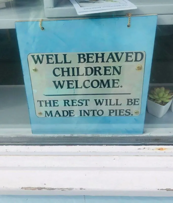 Humorous sign saying well behaved children welcome, rest made into pies, a funny meme for dark and cold winter days.
