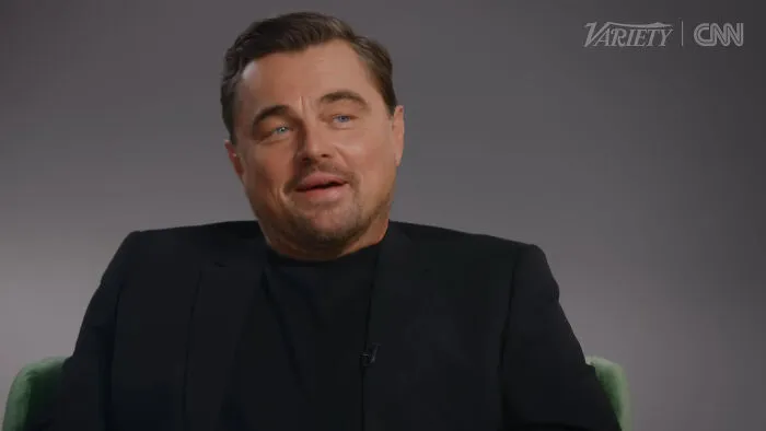 Actor in a black suit speaking in an interview about people think celebrities closet skeletons on CNN and Variety.