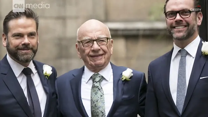 Three men in suits smiling at an outdoor event, illustrating people think celebrities closet skeletons concept.