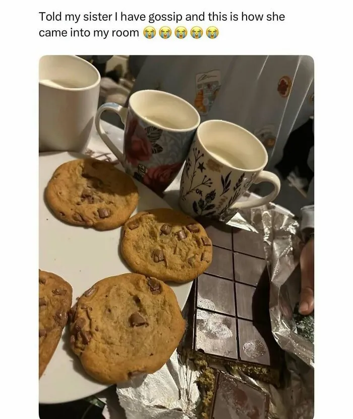 Several chocolate chip cookies on a plate next to mugs and a partially unwrapped chocolate bar, humorous meme about gossip.