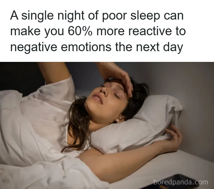 Woman lying awake in bed looking distressed, illustrating psychology facts about poor sleep and emotional reactivity.