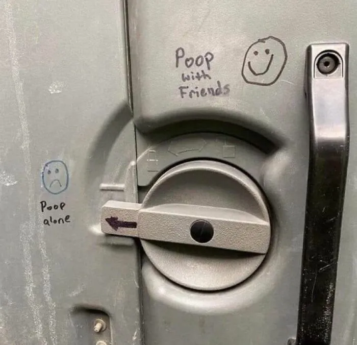 Graffiti on a bathroom door latch showing funny poop alone and poop with friends faces in a meme style.