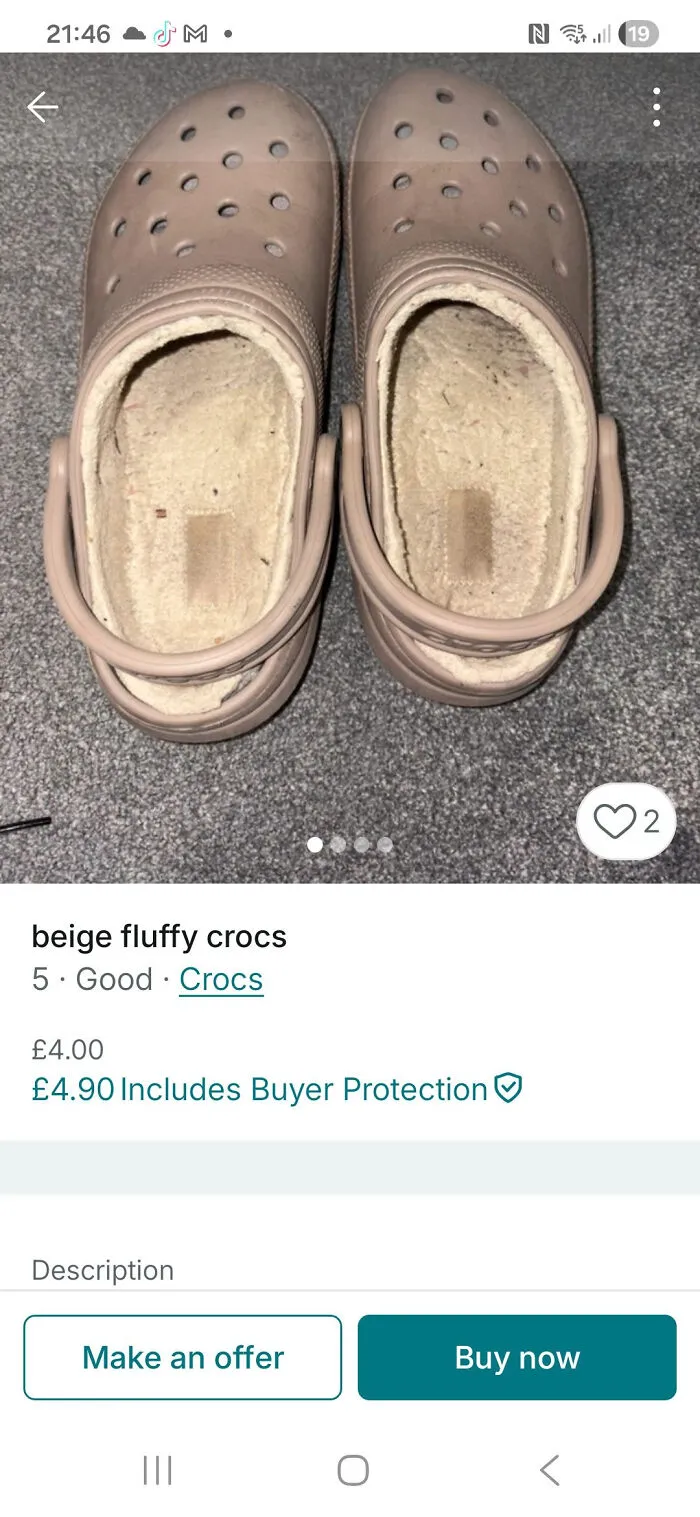 Beige fluffy Crocs with worn inner lining displayed on grey carpet, featured in unusual Vinted posts collection.