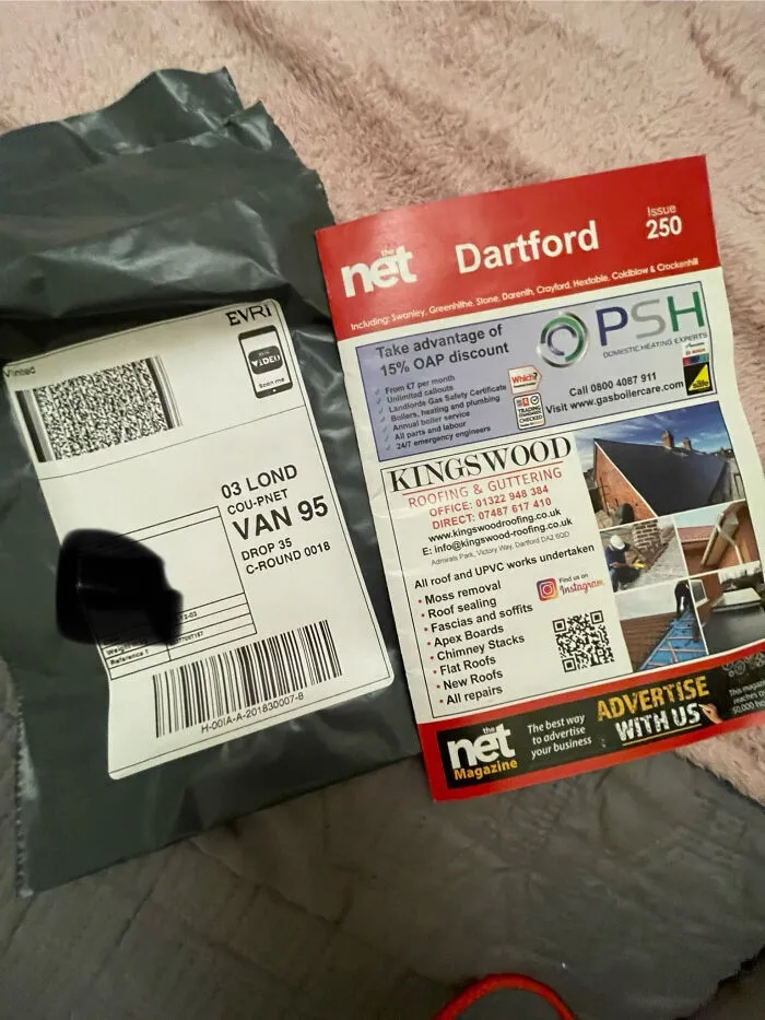 Grey shipping package and local magazine on a soft surface, illustrating unhinged Vinted posts that make people do a second take.