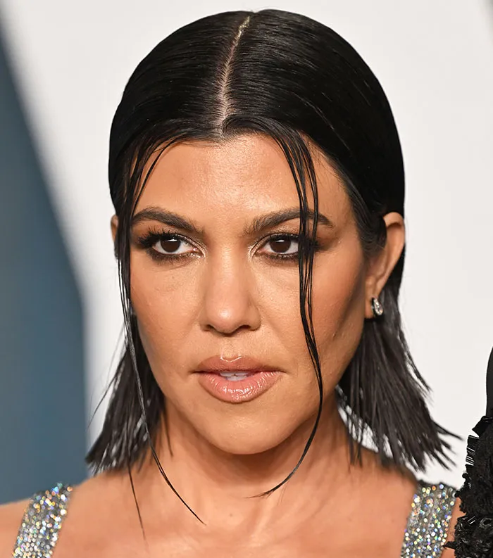 Close-up of a woman with sleek dark hair and makeup, representing the most disliked celebrities of 2025 in pop culture.