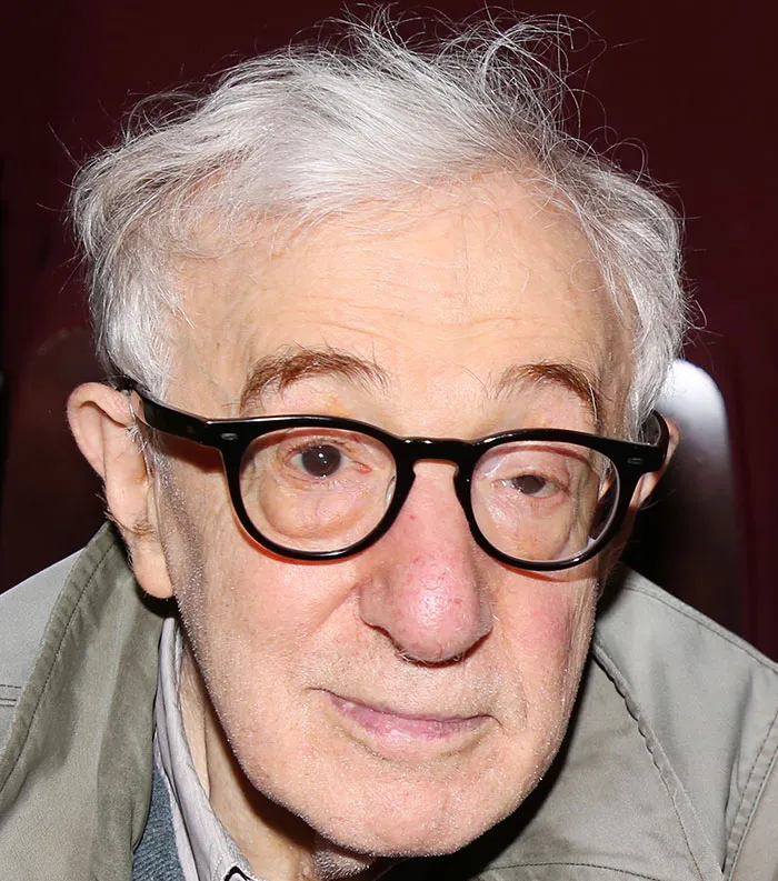 Elderly man with white hair and black glasses, representing most disliked celebrities of 2025 in close-up portrait.