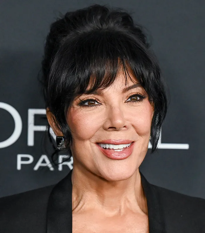 Close-up of a smiling celebrity at an event, representing the most disliked celebrities of 2025.