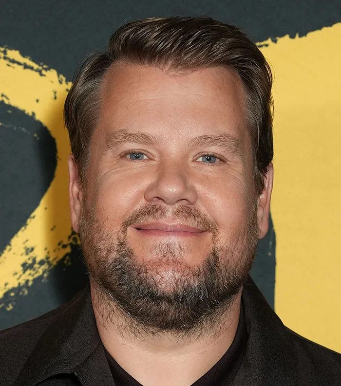 Close-up of a man smiling with a beard and light eyes, representing the most disliked celebrities of 2025.