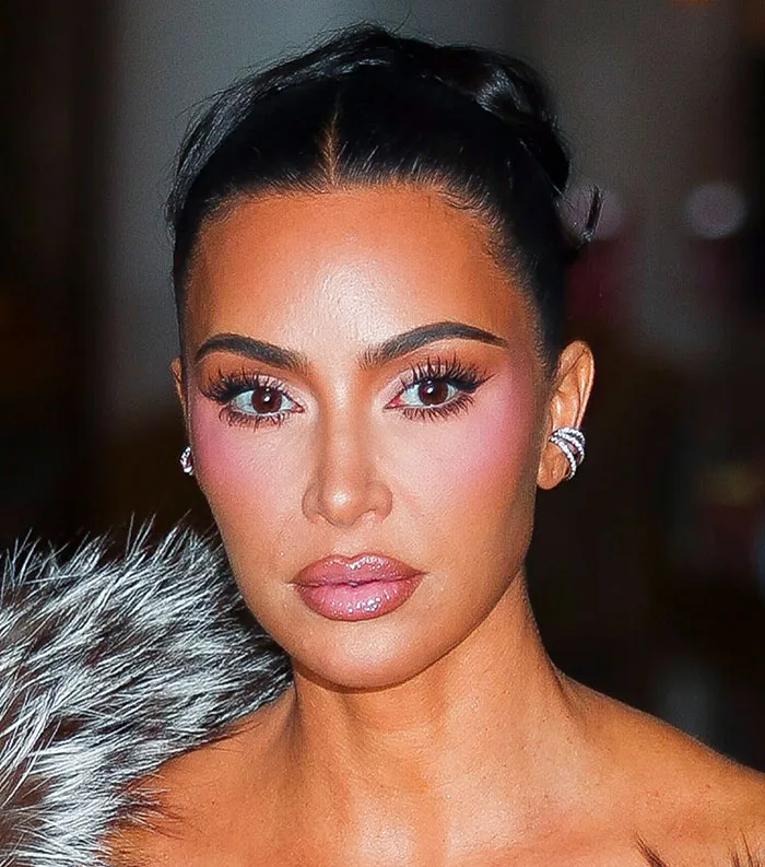 Close-up of a woman with styled hair and makeup, representing the most disliked celebrities of 2025 in a public setting.