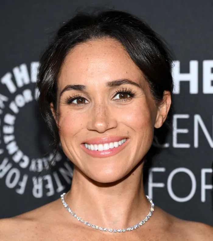 Close-up of a smiling female celebrity at an event, related to the most disliked celebrities 2025 topic.