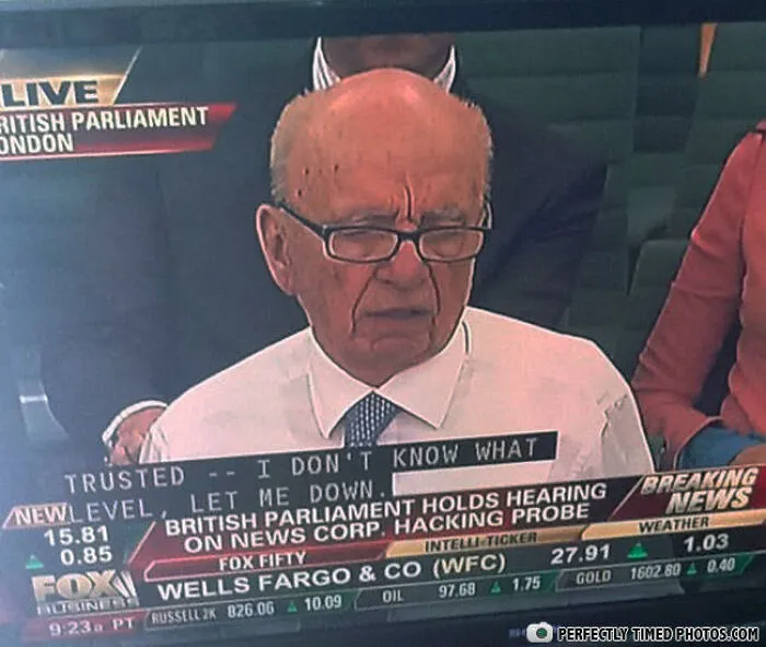 Elderly man with glasses speaking during British Parliament hacking probe hearing, a perfect timed photo moment.