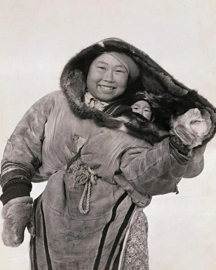 An Inuit Woman Carries Their Babies In Cold Weather Clothing, 1940