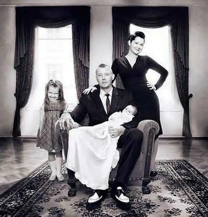 Black and white vintage family portrait with eerie expressions, fitting the odd and creepy theme of old photos.