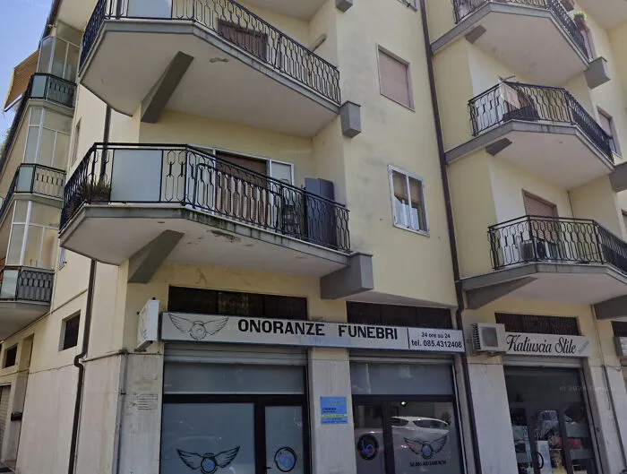Italian Funeral Home (Onoranze Funebri) With Coffin-Shaped Balconies On The Floors Above
