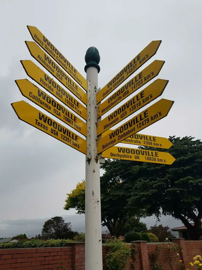 Directional signpost showing multiple Woodville locations worldwide, highlighting impressive things countries implemented to leave people in awe.