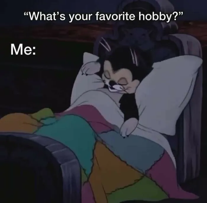 Animated cat sleeping in bed under a colorful quilt, illustrating humor as a coping mechanism meme.