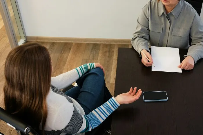 Two coworkers having a tense discussion in an office, illustrating the worst coworkers ever making work difficult.