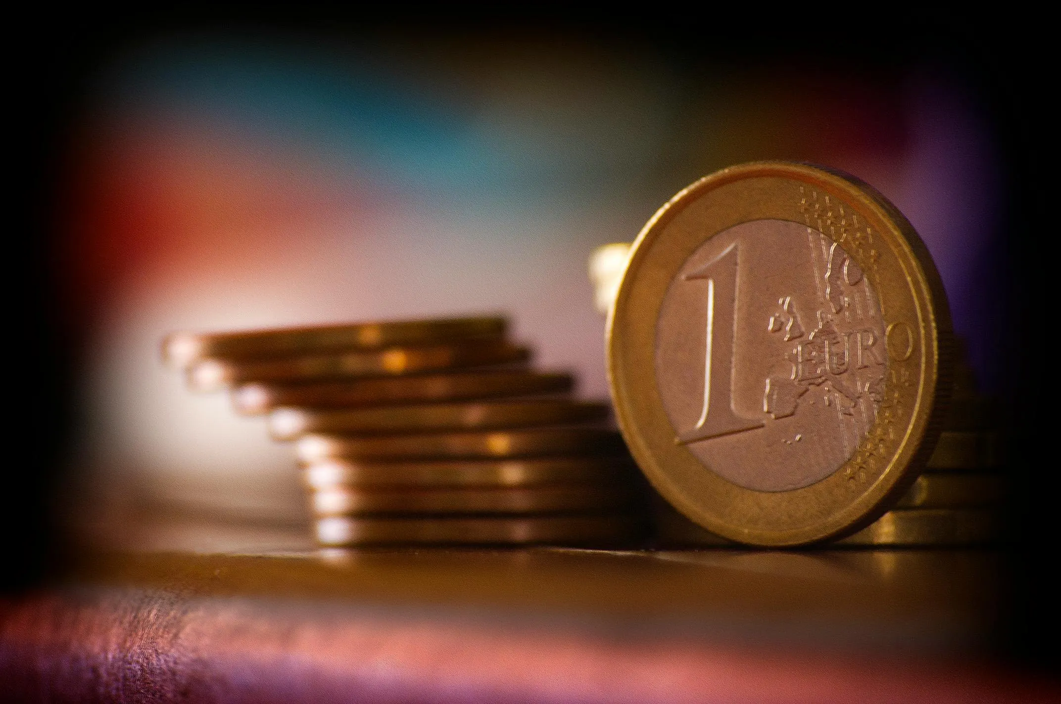Stack of euro coins with a focus on a one euro coin, representing deadly decoys using euro currency.