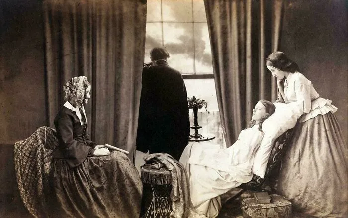 Victorian era family scene with woman seated, man by window, and young woman reclining on a sofa in vintage clothing.