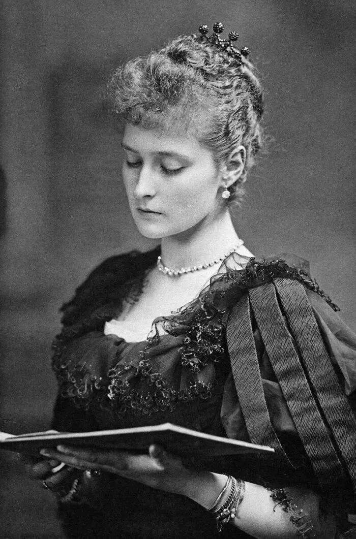 Victorian era woman wearing elegant dress and jewelry, intently reading a book, showcasing Victorian era fashion and lifestyle.