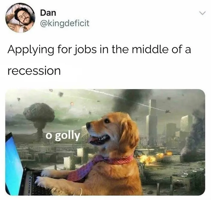 Dog in a tie using laptop with explosions in the background illustrating recruitment nightmares during a recession.