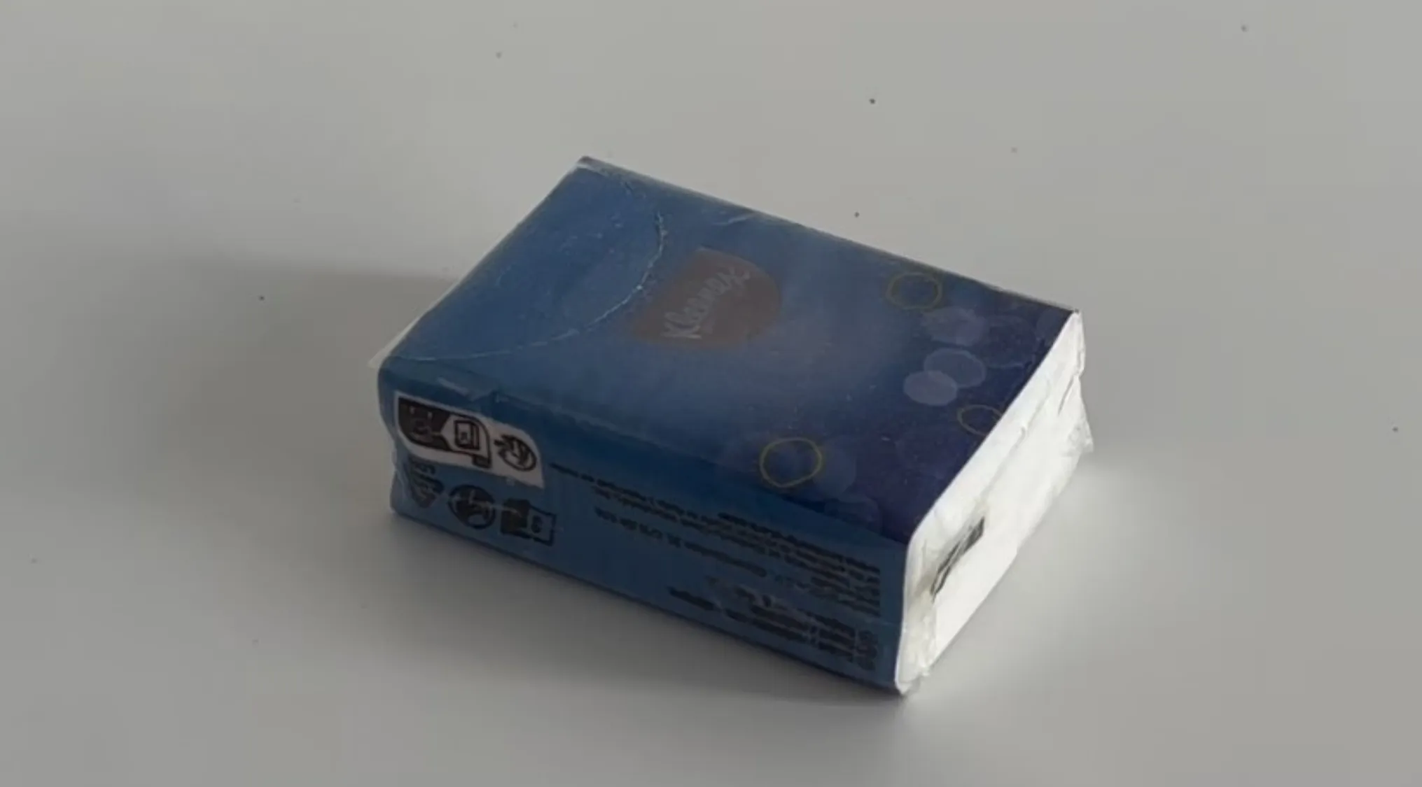 Blue pack resembling napkins placed on a white surface in an is it real or cake visual challenge.
