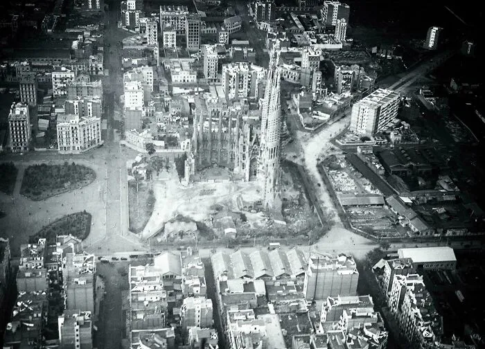 Aerial black and white photo of historic site surrounded by city buildings showcasing architectural history perspective.