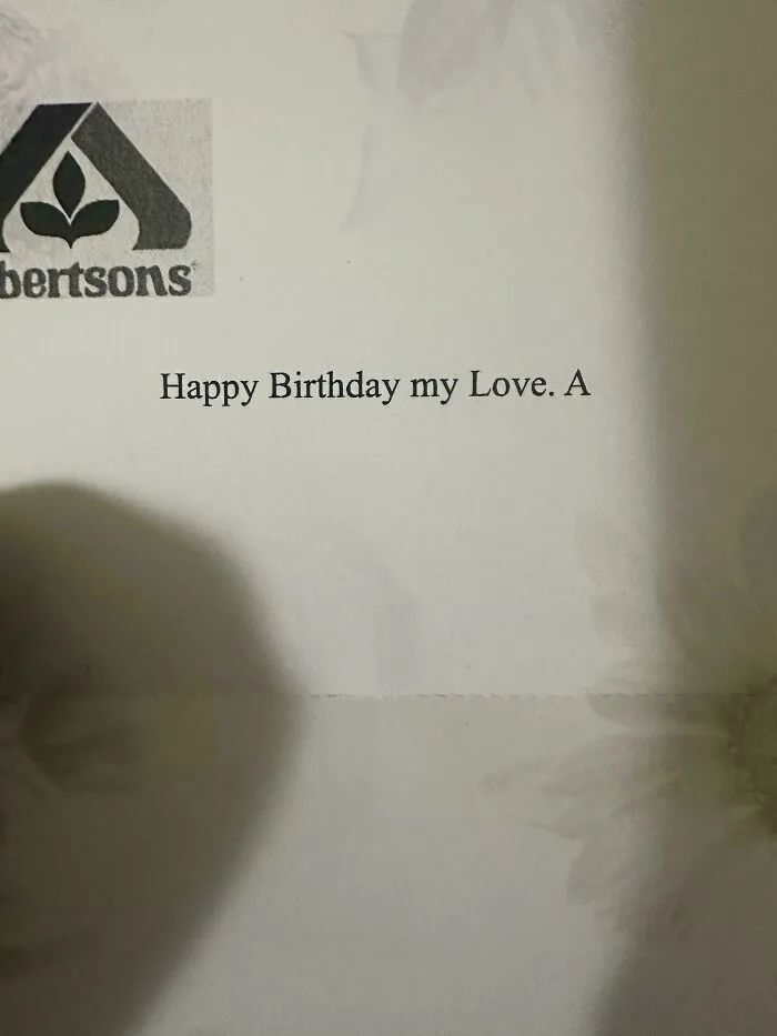 Unfortunate events shown in a printed birthday note with an incomplete message on floral paper background.