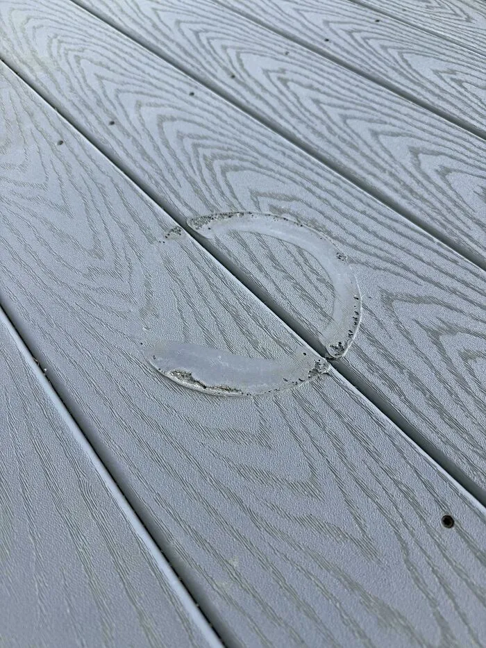 Faded ring stain on wood deck showing an unfortunate event among photos that make you feel better about your day.