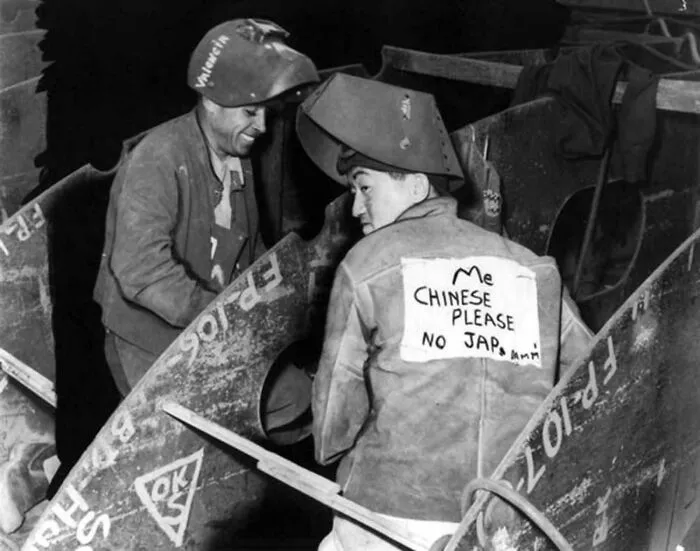 Chinese American With A Note That Says He Is Chinese, Not Japanese, To Avoid Harrasment At Work, 1940s