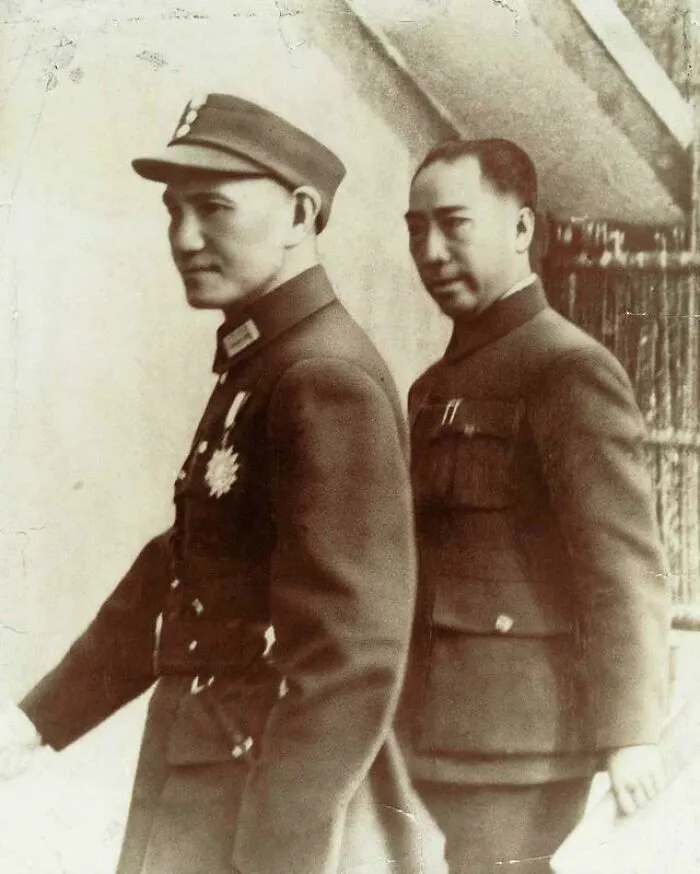 Two men in vintage military uniforms in a historical photograph depicting a world you'd hardly recognize today.