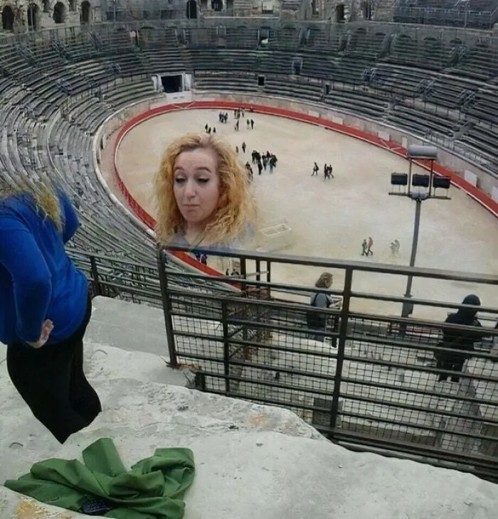 Distorted panoramic photo fail showing a large amphitheater with a duplicated, floating head of a woman.