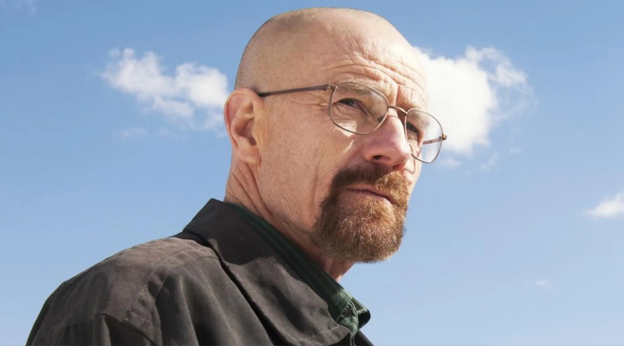 Close-up of Walter White from Breaking Bad wearing glasses against a blue sky, related to trivia night physics teacher question